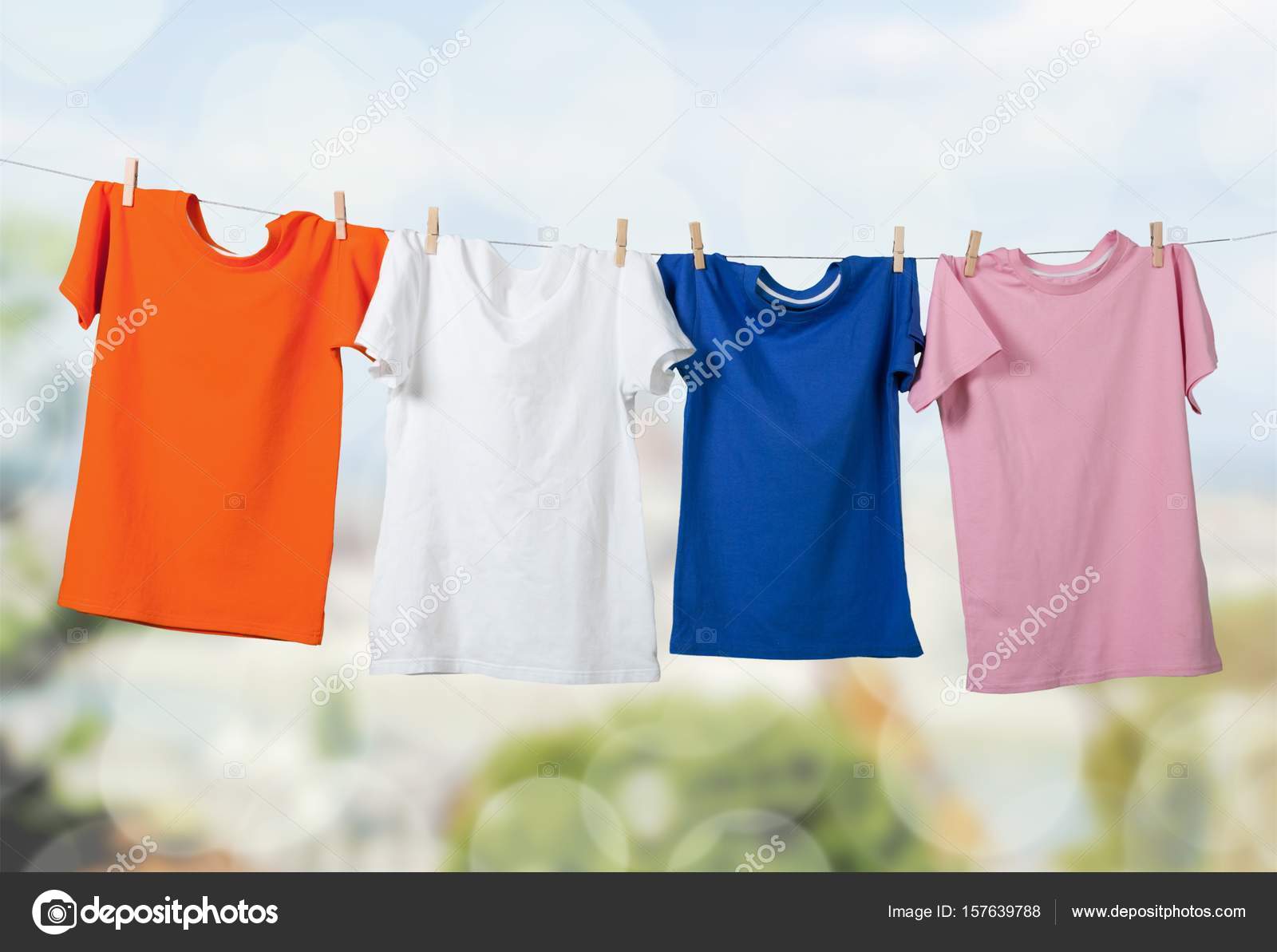 Wash clothes on a rope with clothespins Stock Photo by