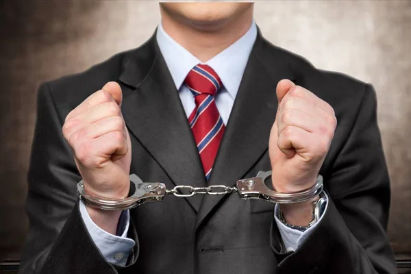 Man in metal handcuffs — Stock Photo, Image