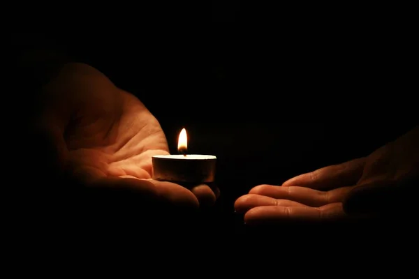 Candle in male hands — Stock Photo, Image