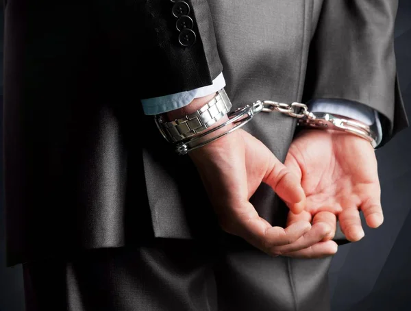 Man in handcuffs behind his back — Stock Photo, Image