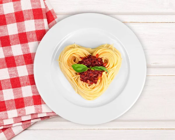 Pasta with sauce in shape of heart — Stock Photo, Image