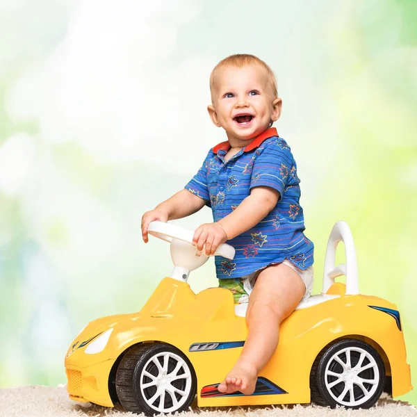 Cute boy in yellow toys car — Stok Foto