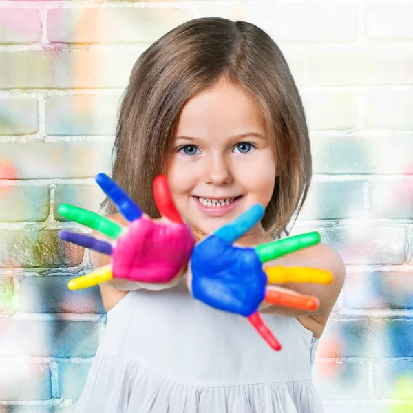Маленькая девочка показывает окрашенные руки — стоковое фото