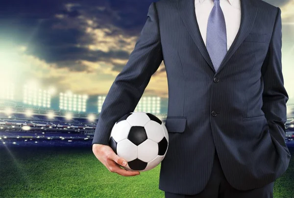 Hombre de negocios sosteniendo pelota de fútbol — Foto de Stock