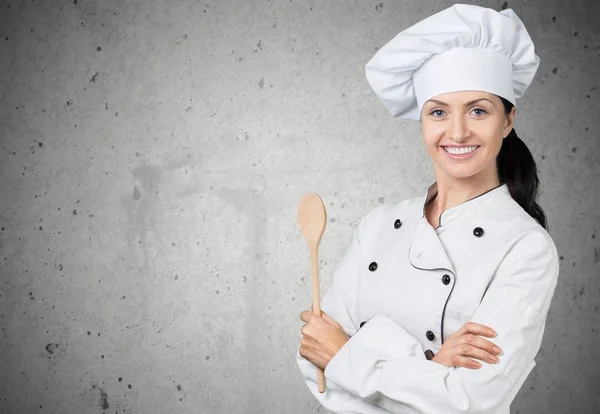 Young female chef with wooden spoon — Stock Photo, Image