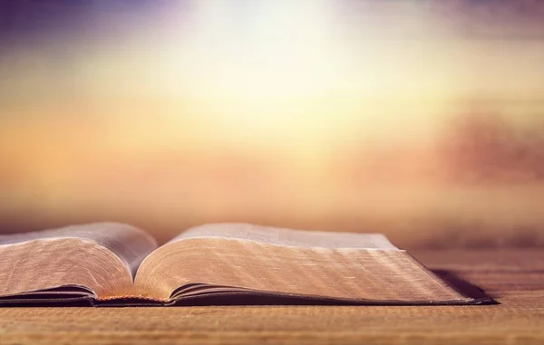 Holy bible with candle — Stock Photo, Image