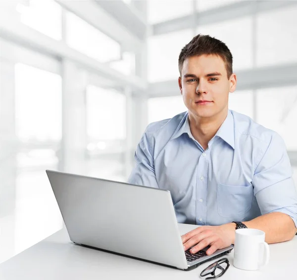 Jovem feliz trabalha em seu laptop — Fotografia de Stock