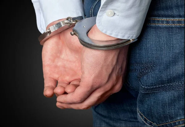 Man in handcuffs behind his back — Stock Photo, Image