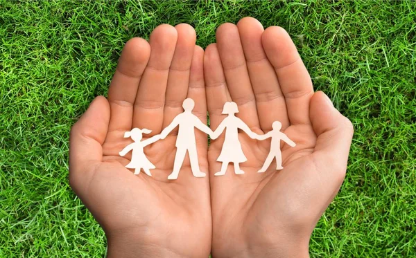 Hands with family of paper people — Stock Photo, Image