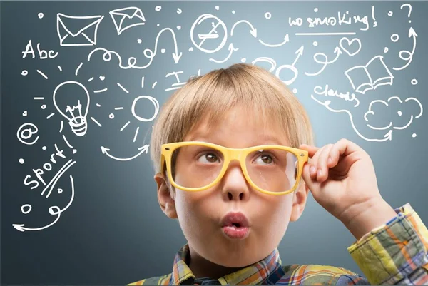 Young boy in  glasses thinking — Stock Photo, Image