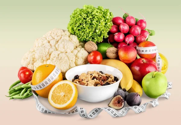 Fruits with vegetables and measuring tape — Stock Photo, Image