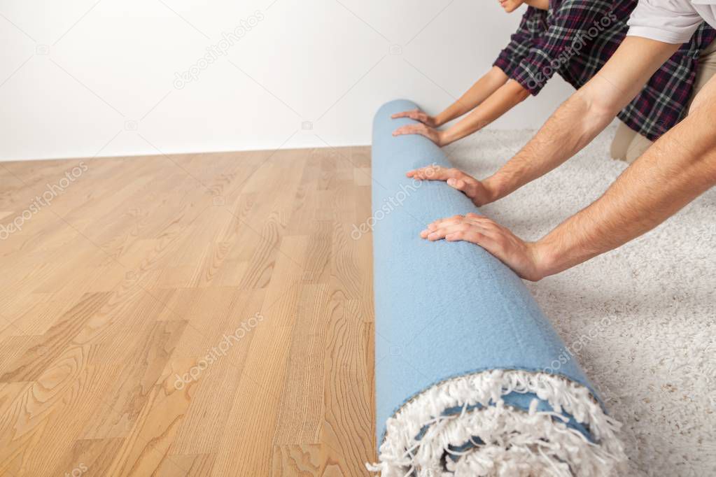 human hands rolling carpet