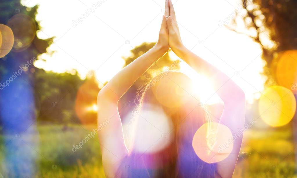 woman doing yoga in sunset light