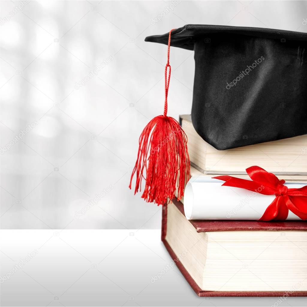 Graduation mortarboard on stack of books