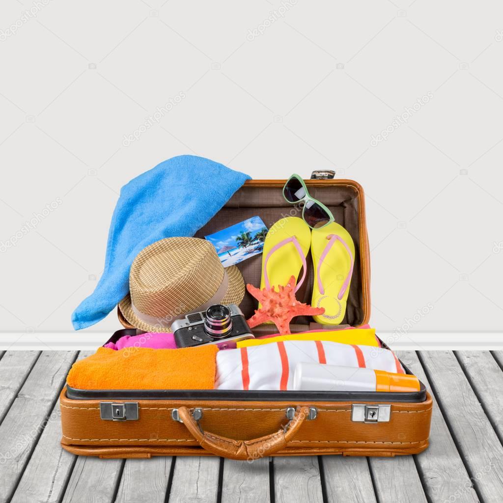 travel suitcase with hat, flip-flops 