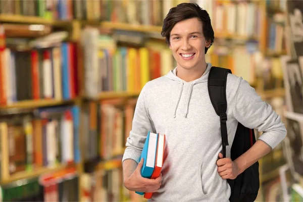 Jovem segurando livros — Fotografia de Stock