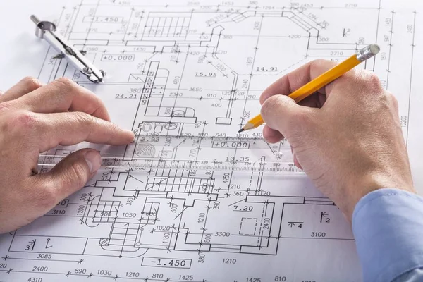 Architect working on construction blueprint — Stock Photo, Image