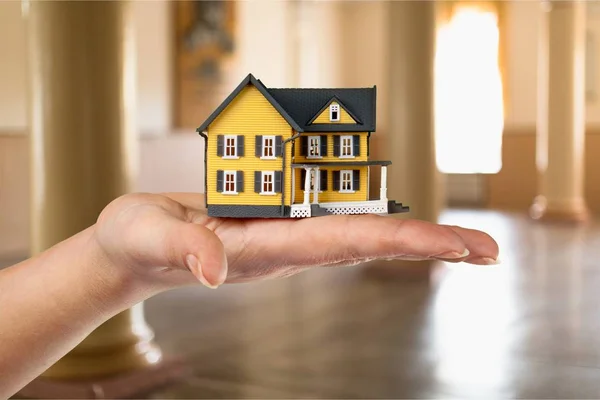 hand holding house model