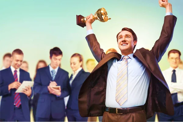 Business team with gold trophy — Stock Photo, Image