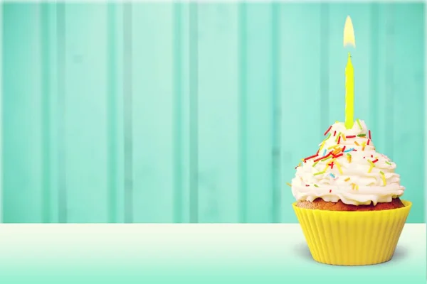 Cupcake with cream and candle — Stock Photo, Image