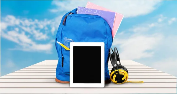 School Backpack  with tablet and earphones — Stock Photo, Image