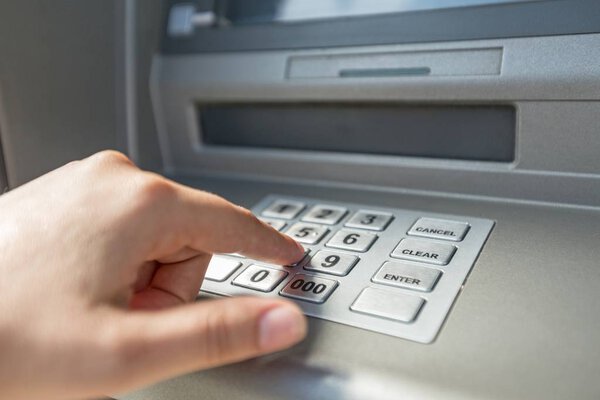 Hand pushing button on ATM