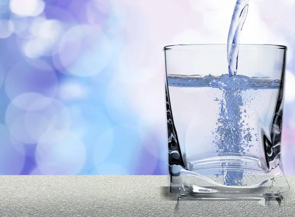 Agua vertiendo en el vidrio — Foto de Stock