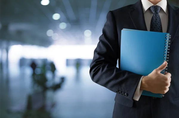 Handsome businessman holding notepad — Stock Photo, Image