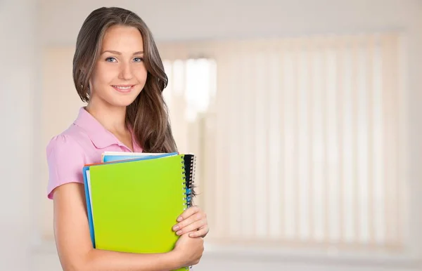 Young female student with notebooks — Stock Photo, Image