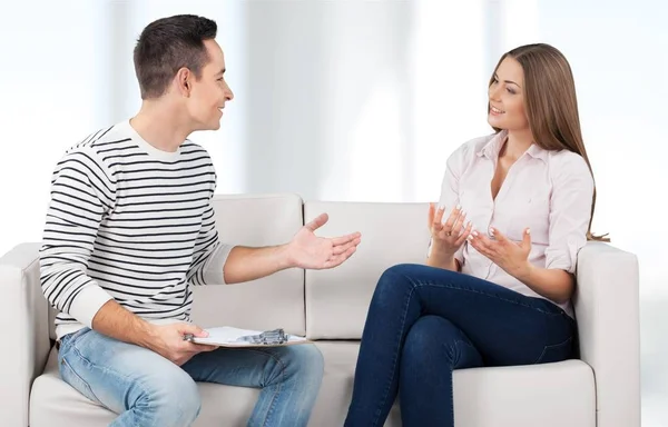 Sonriente pareja en sofá en casa — Foto de Stock