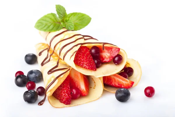 Heap of rolled pancakes with berries — Stock Photo, Image
