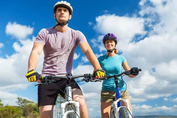 Happy couple riding bicycle outdoors — Stock Photo, Image