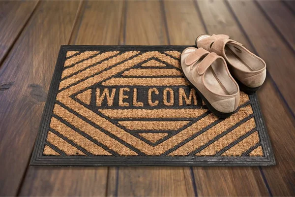 shoes on welcome doormat