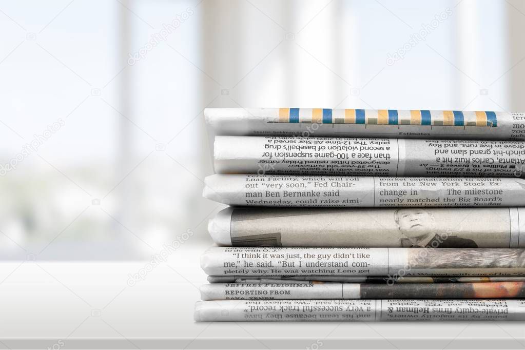 pile of printed newspapers