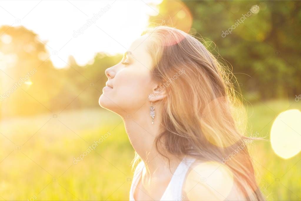 Woman under sunset light