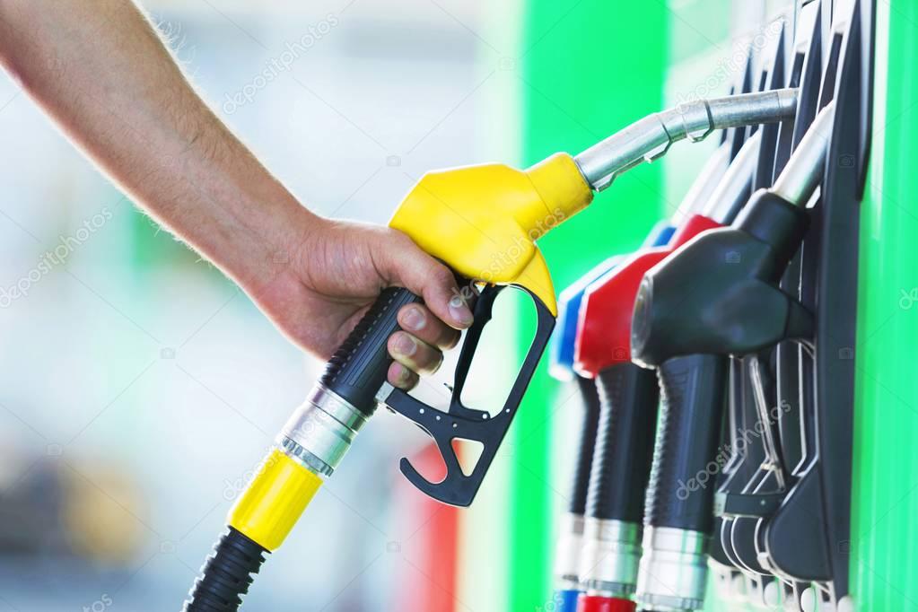 man's hand holding a petrol pump 