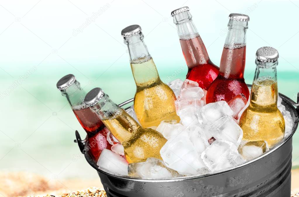 bottles of beer in bucket with ice