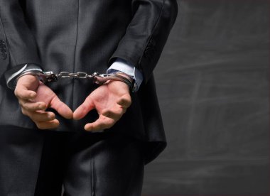 Adam arkadan kelepçeli