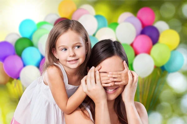 Girl covering her mother eyes — Stock Photo, Image