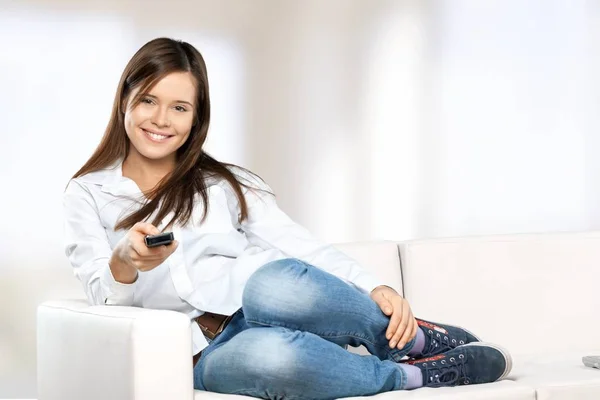 Woman with tv remote control — Stock Photo, Image