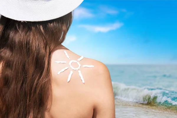 Woman with sun sign on back — Stock Photo, Image
