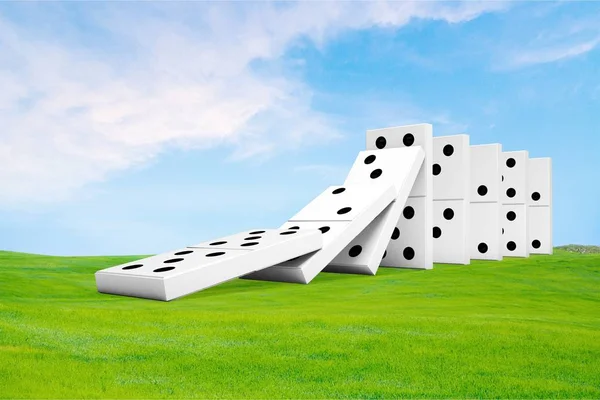 Dominoes on grass and sky — Stock Photo, Image