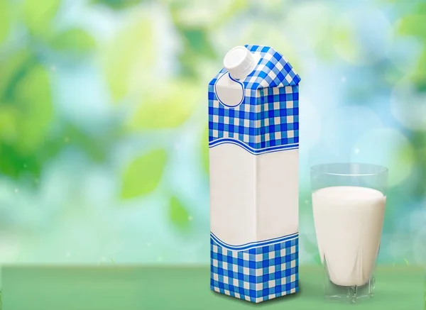 Milk in glass and box — Stock Photo, Image