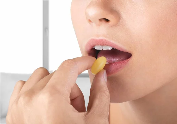 Woman taking a tablet — Stock Photo, Image