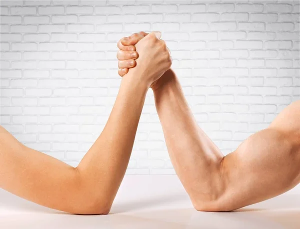 Man and woman armwrestling Stock Picture