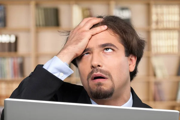 Businessman using laptop with signs — Stock Photo, Image