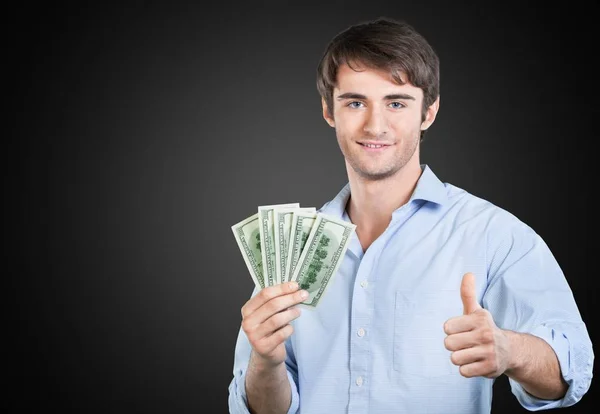 Человек с долларами, показывающий большой палец вверх — стоковое фото