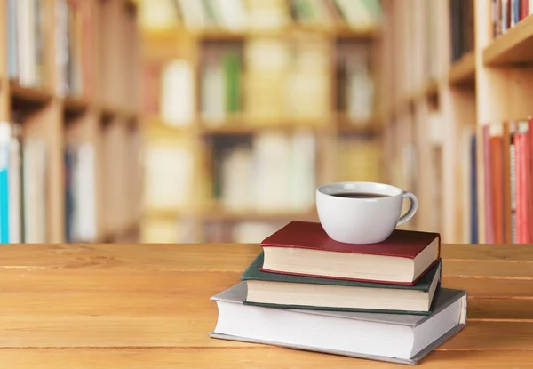 Pile of books with coffee cup — Stock Photo, Image