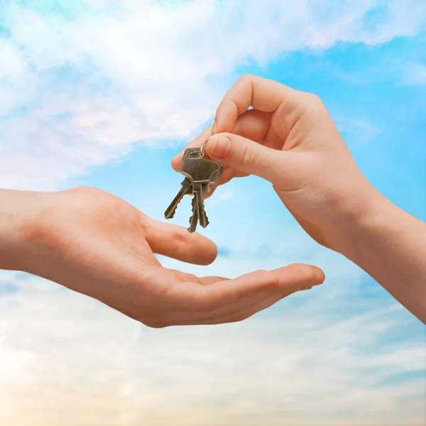 Hand giving set of house keys — Stock Photo, Image