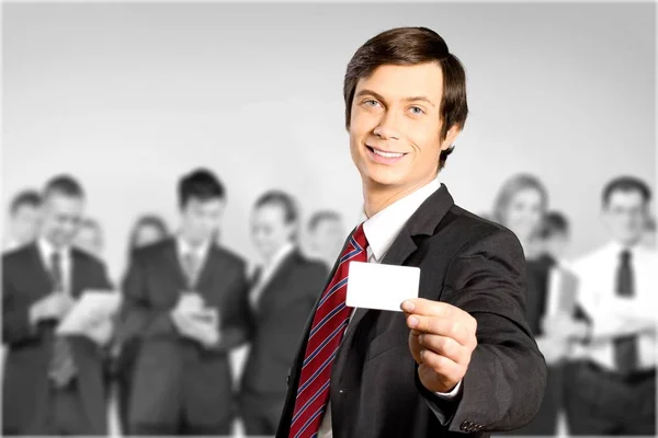 Businessman in suit with card — Stock Photo, Image